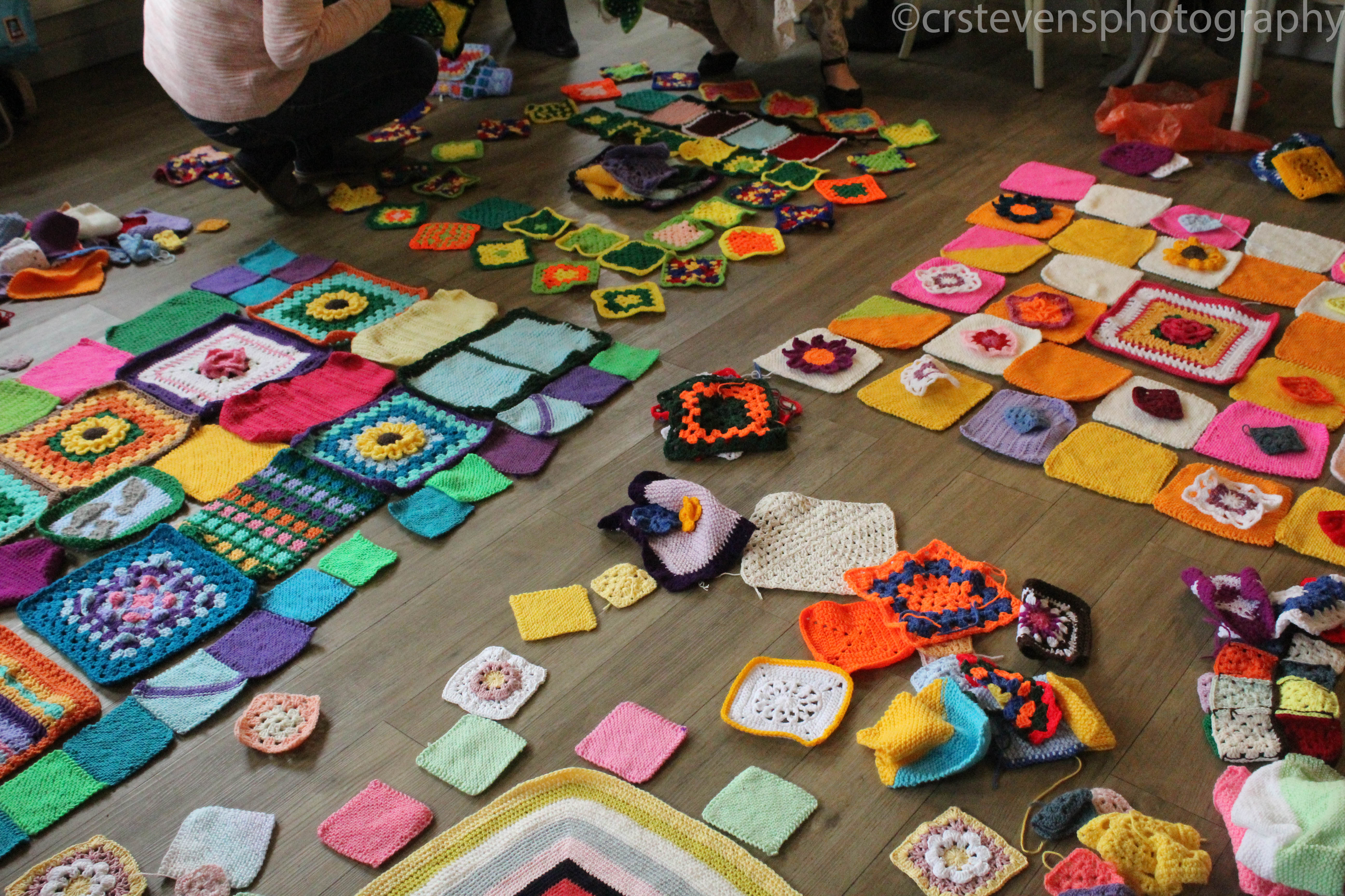 the floor of a room covered in granny squares